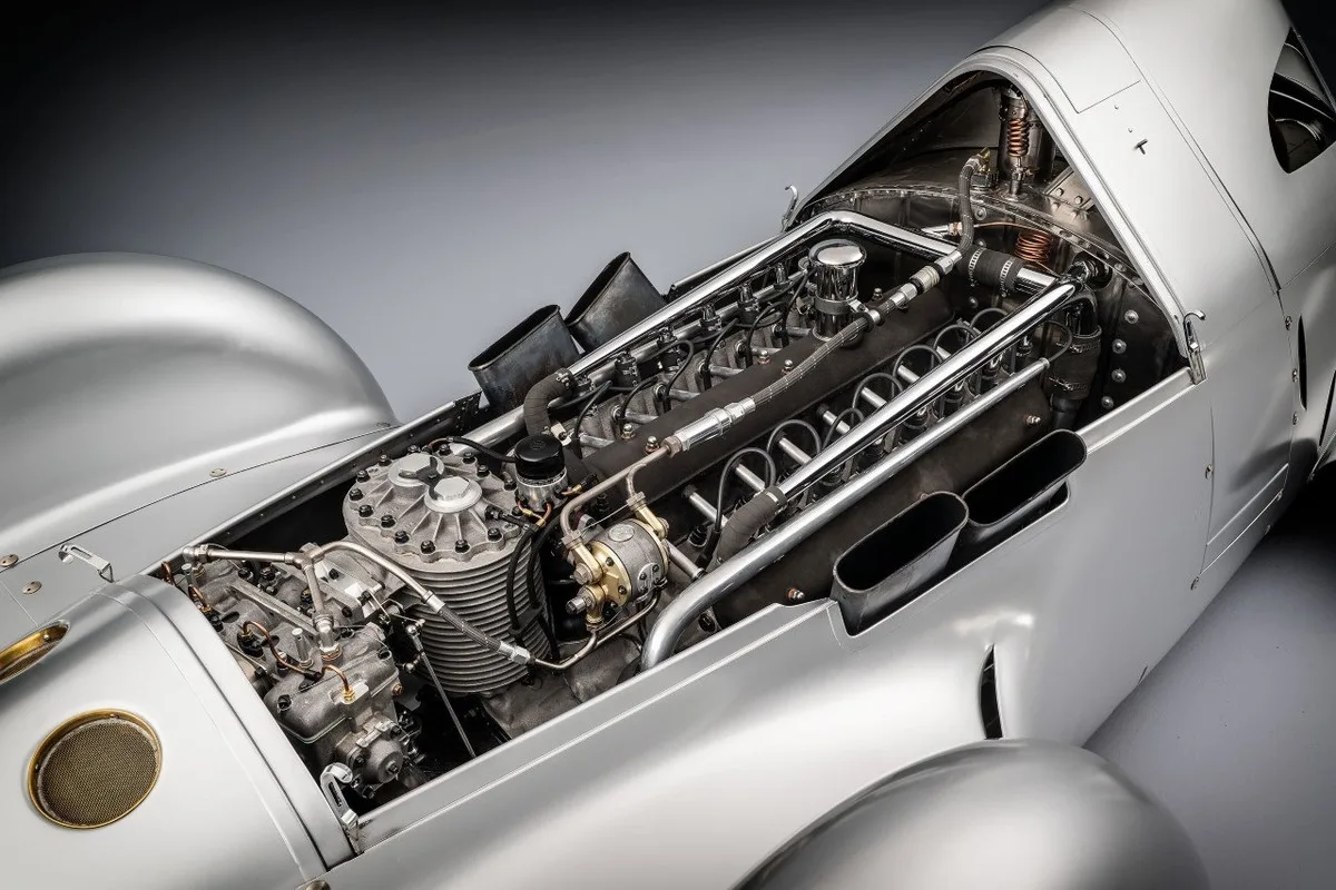 Auto Union Type 52 with exposed engine and polished bodywork.