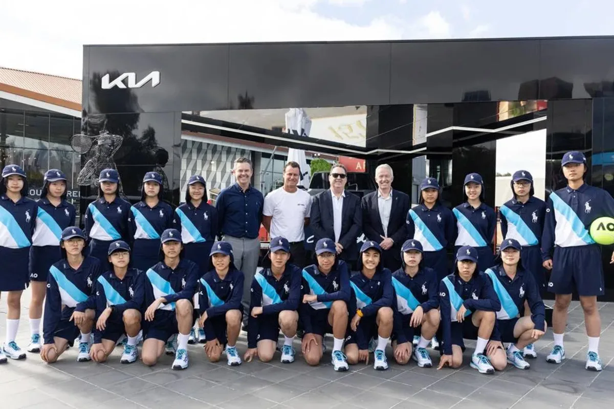 Damien Meredith with Kia Australia representatives and Australian Open ballkids at a Kia event.