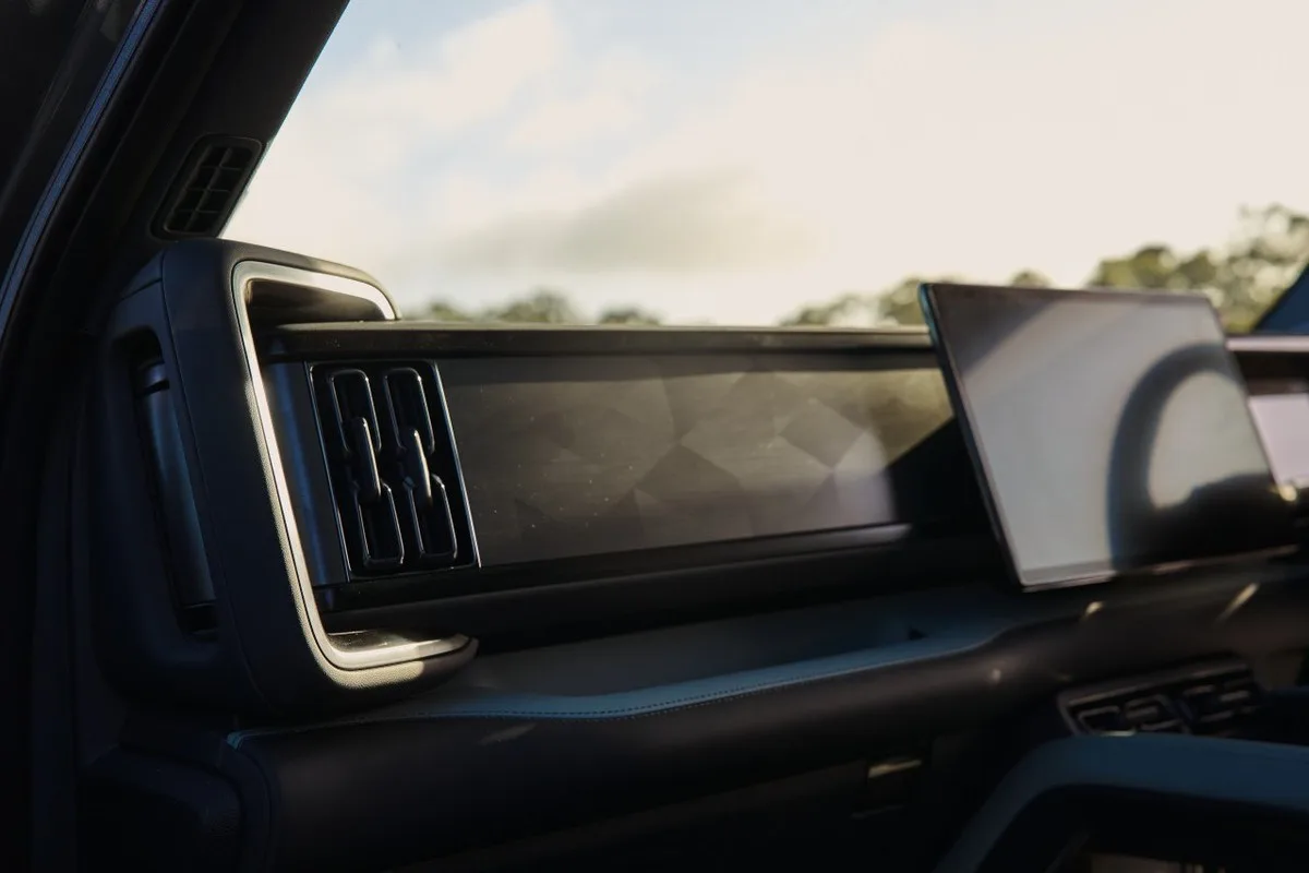 Denza B8 dashboard detail with central infotainment screen, air vents and dark cabin trim.