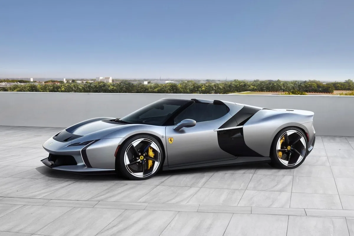Ferrari HC25 One-Off silver roadster in side view on a light stone terrace.