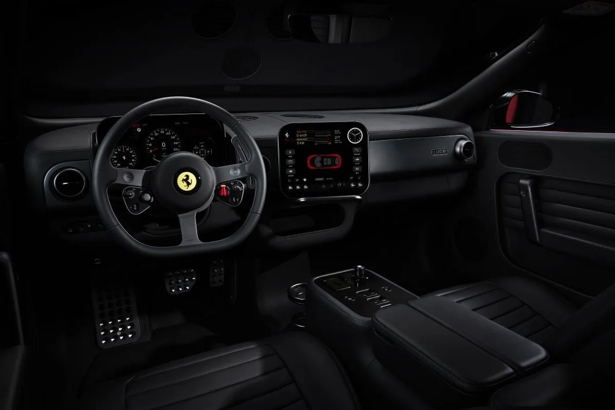 Ferrari Luce black cabin showing steering wheel, touchscreen and centre console
