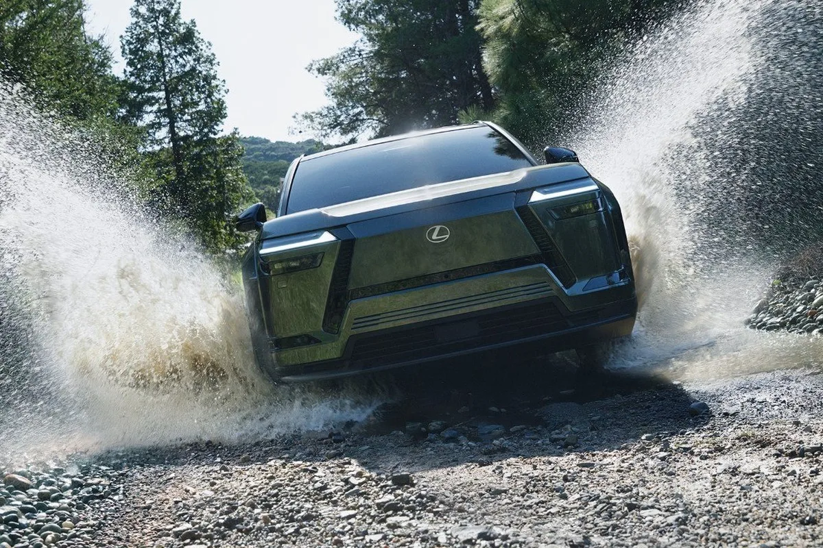 Lexus TZ electric SUV driving through a shallow water crossing.