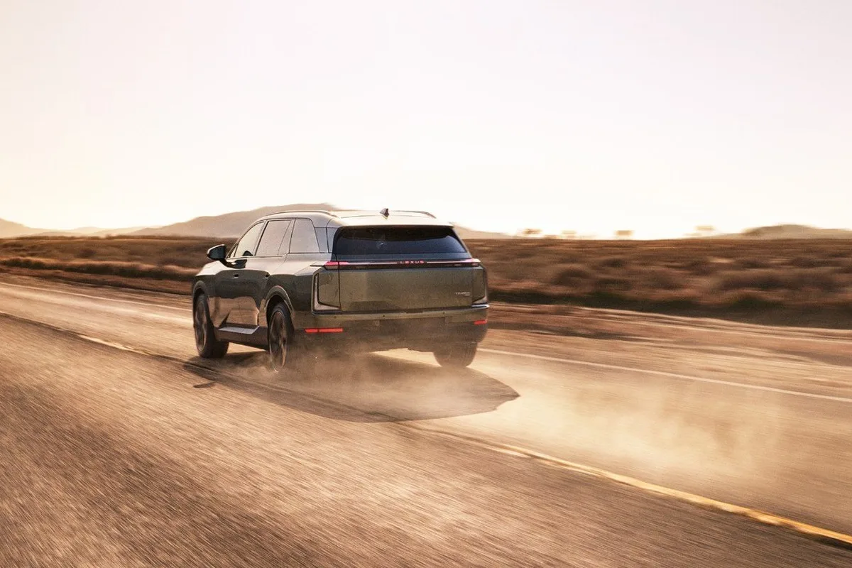 Lexus TZ electric SUV driving on a desert road.