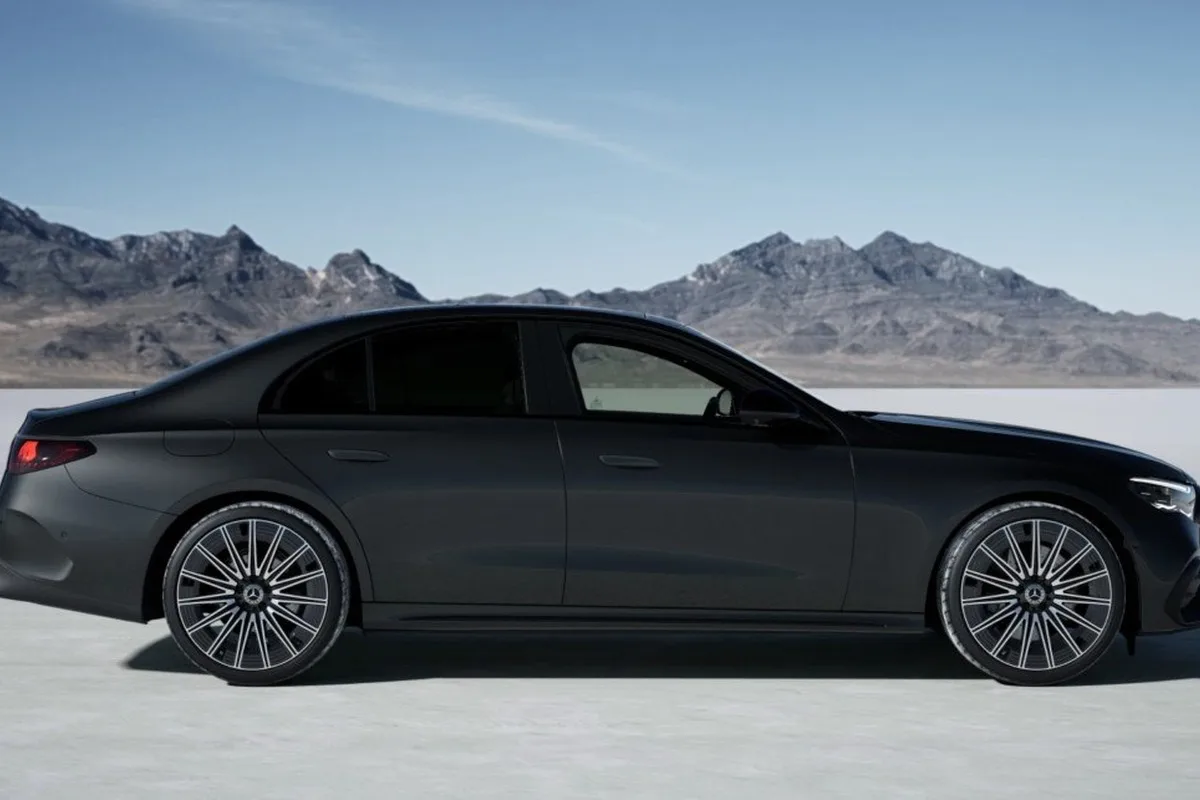 Dark Mercedes-AMG E 53 HYBRID Dark Carbon Edition side profile with black AMG forged wheels.