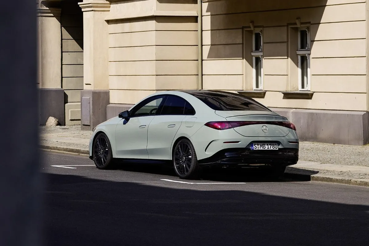 All-new Mercedes-Benz CLA rear three-quarter view parked in the city.