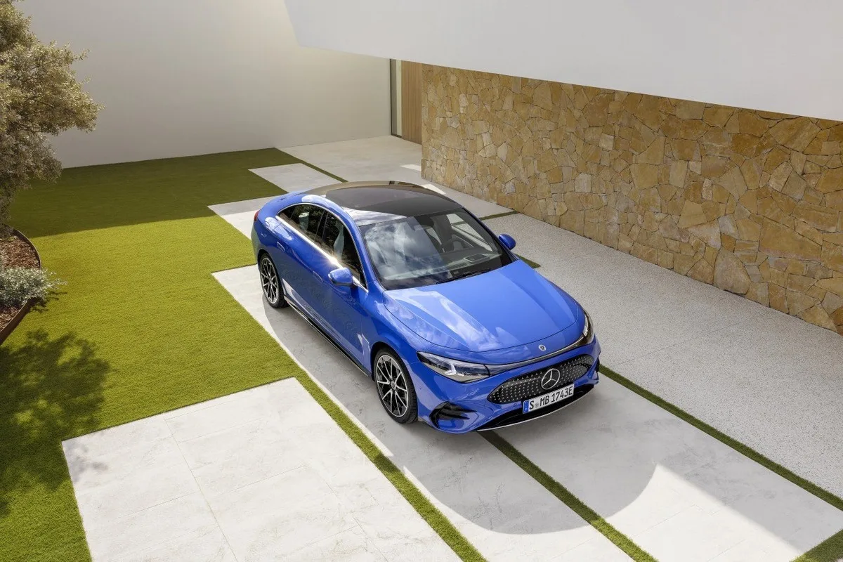 Blue Mercedes-Benz CLA electric parked on a modern driveway.