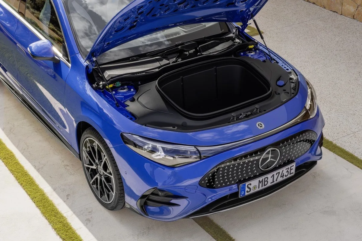 Blue Mercedes-Benz CLA electric with its front storage compartment open.
