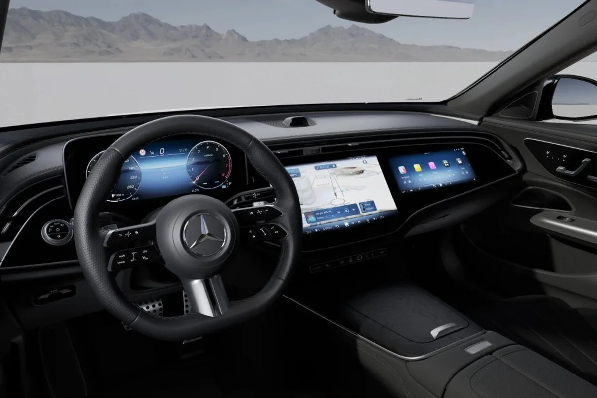 Mercedes-Benz E-Class interior with MBUX display, digital instruments and front cabin trim.