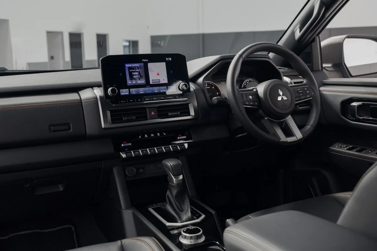 Mitsubishi Triton Raider dashboard with touchscreen, right hand drive steering wheel and centre console.