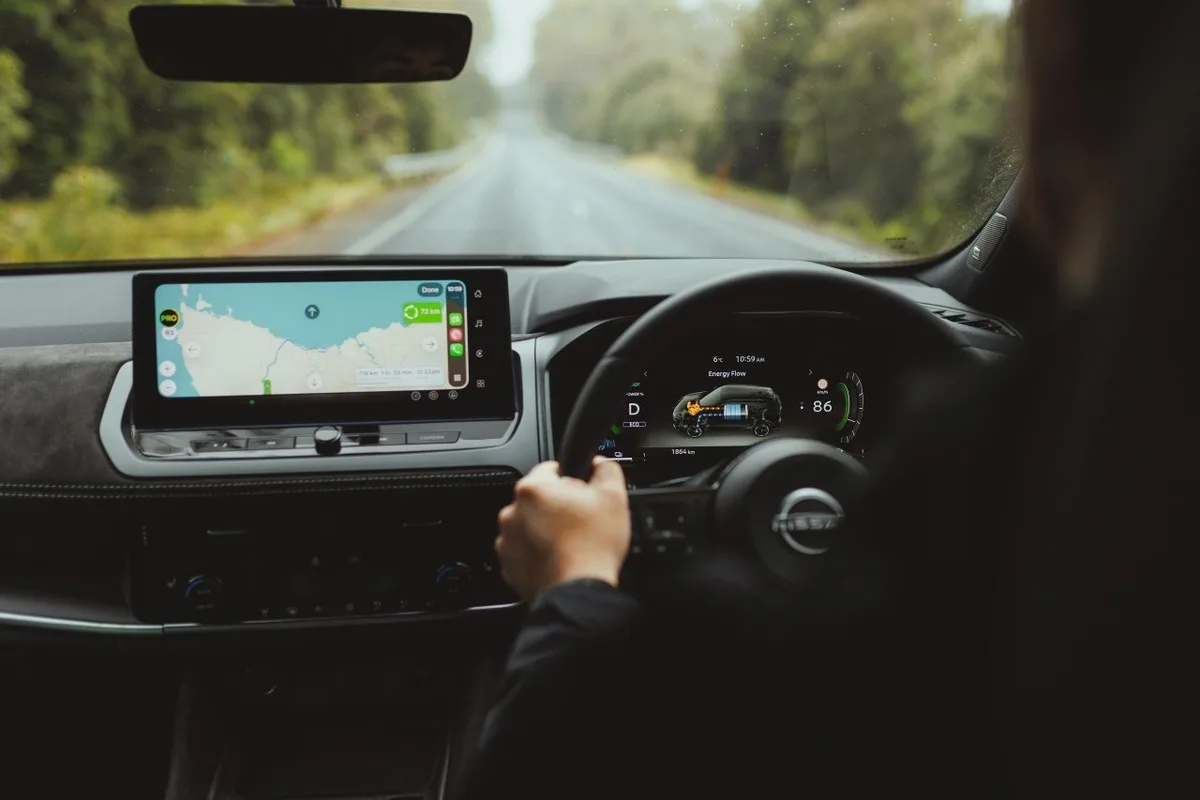 Nissan Qashqai e-POWER cabin view with navigation running on a forest road.