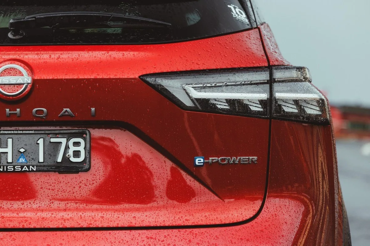 Close-up of the Nissan Qashqai e-POWER rear badge on the red tailgate.