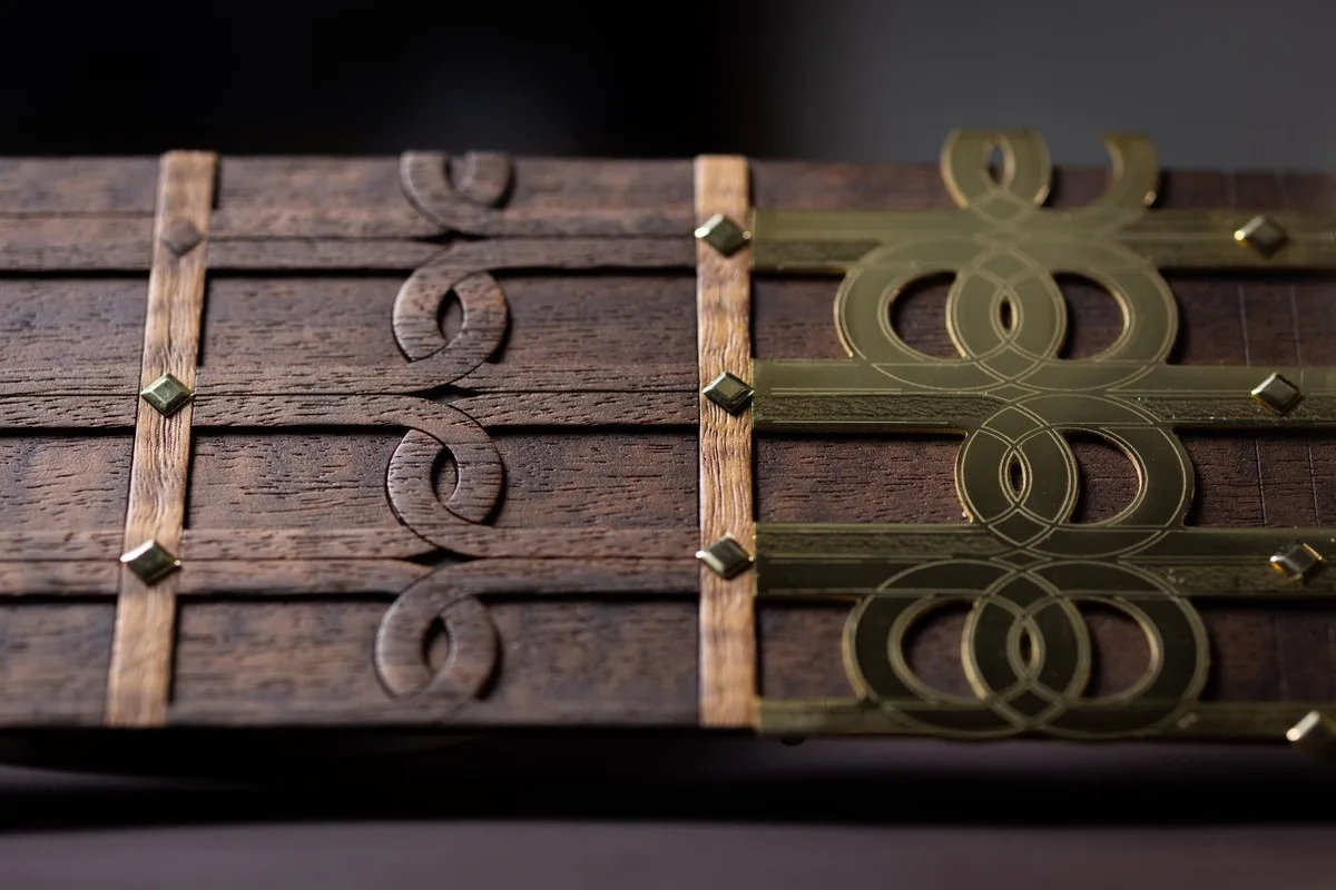 Rolls-Royce Bespoke decorative wooden panel with brass-toned geometric inlay and stud details.