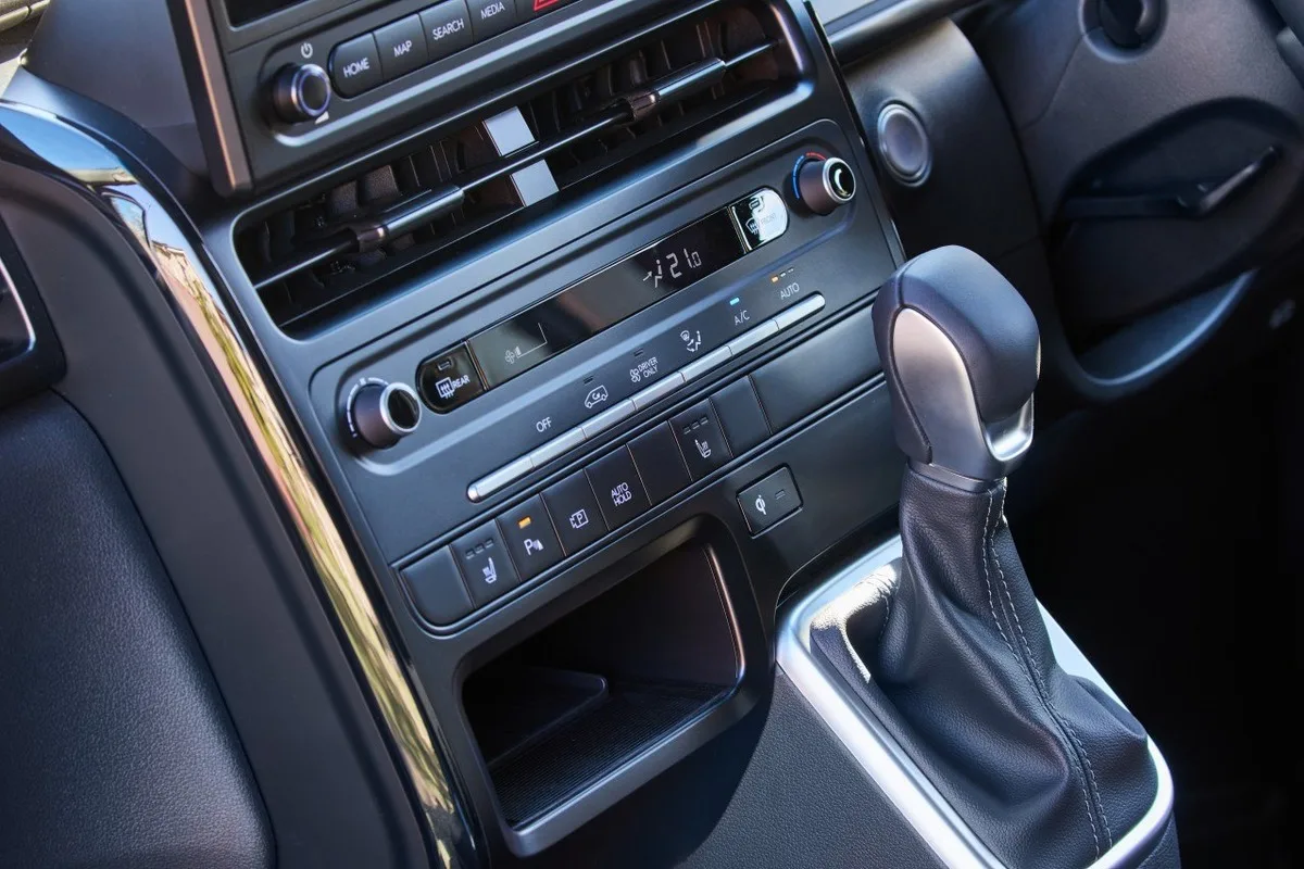 2027 Hyundai Staria centre console showing climate controls, gear selector, and charging pad