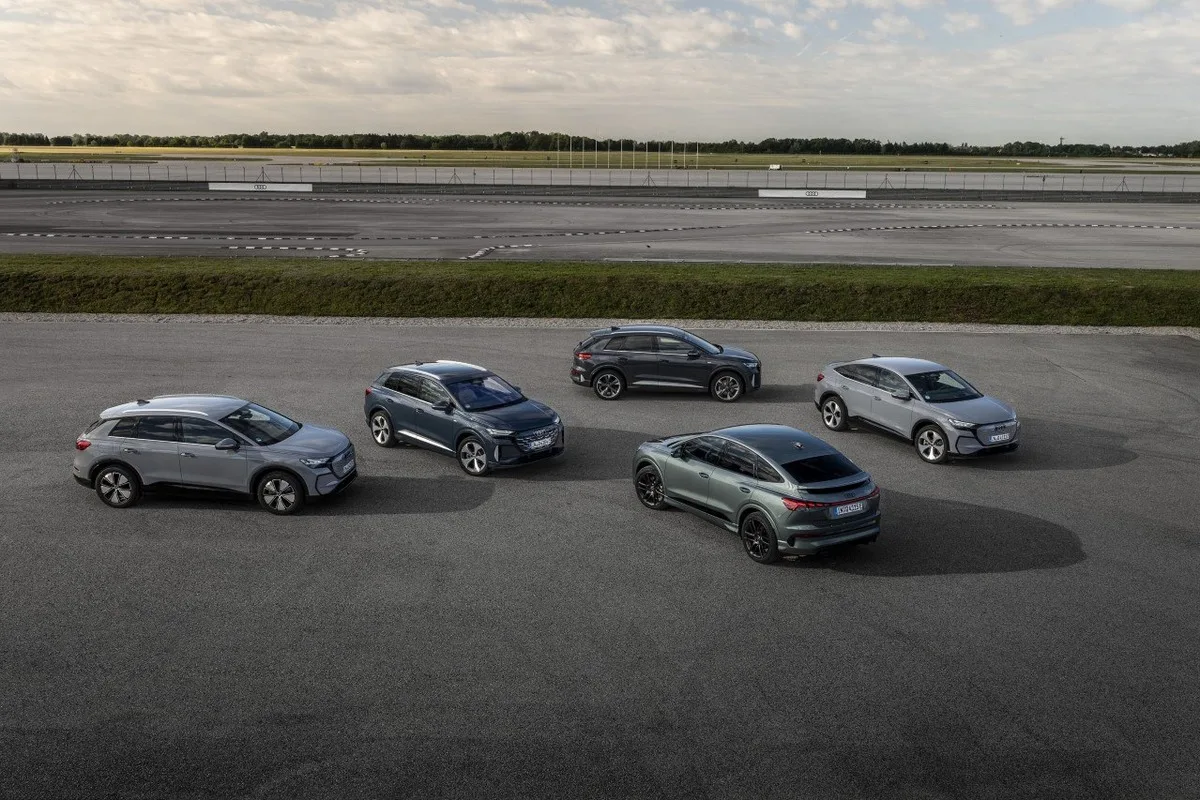 Audi Q4 e-tron SUV and Sportback models parked together on a test ground.