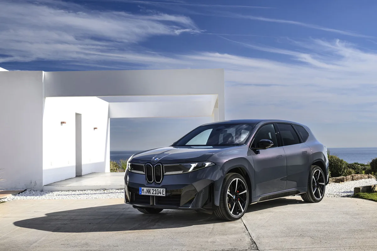 2026 BMW iX3 40 Neue Klasse electric SUV parked in front of modern white architecture