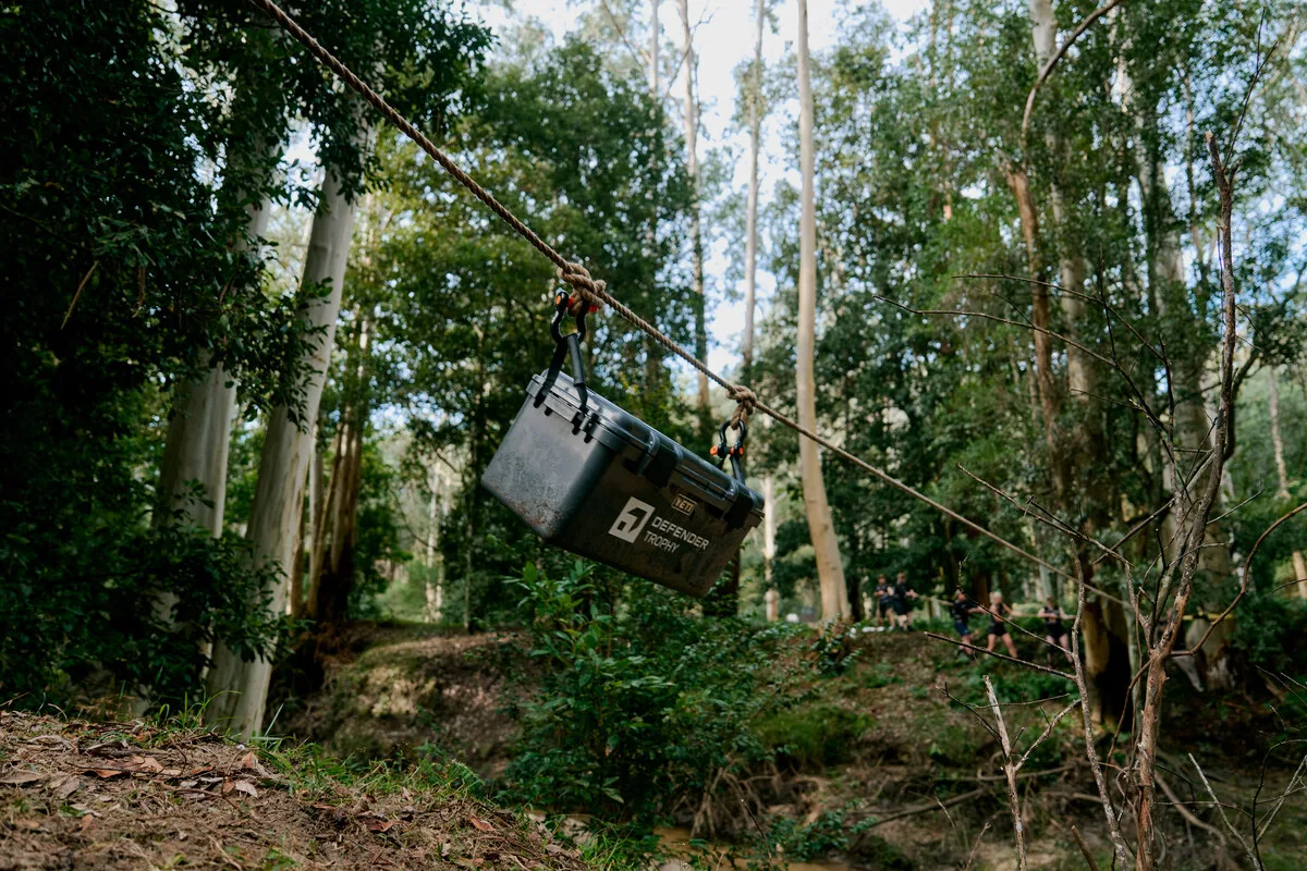Yellow Defender 110 Trophy moving along a bush track during the Australian qualifier