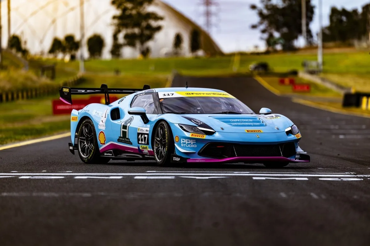 Blue Ferrari Challenge race car crossing the line at Queensland Raceway.