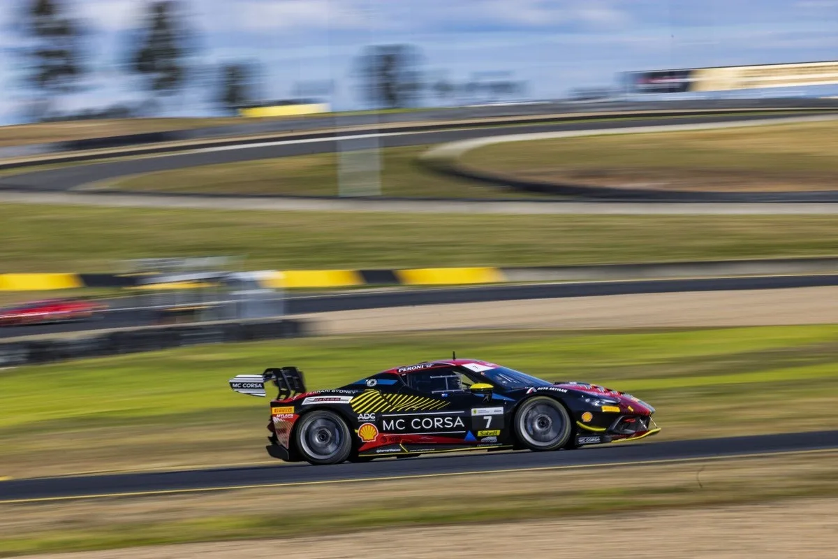 Ferrari Challenge race car captured in a panning shot on track at Queensland Raceway.