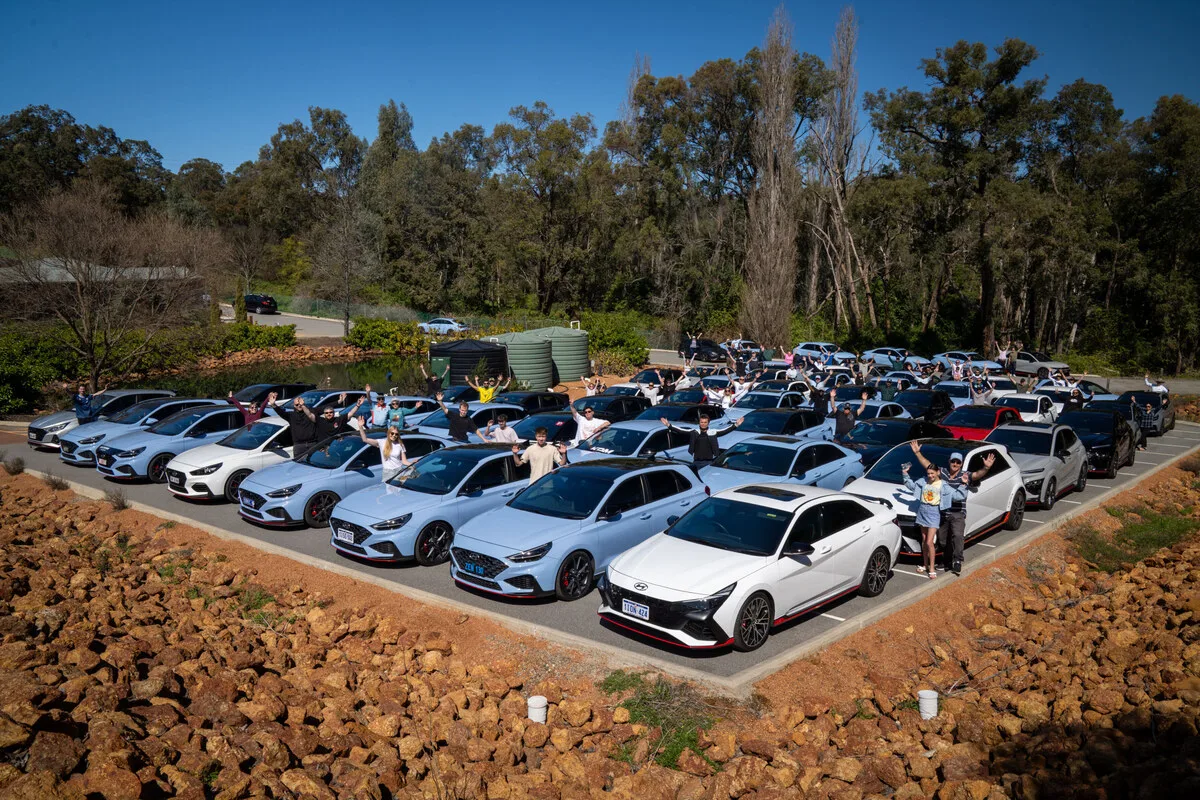 Hyundai N owners with i30 N and Elantra N at a community gathering