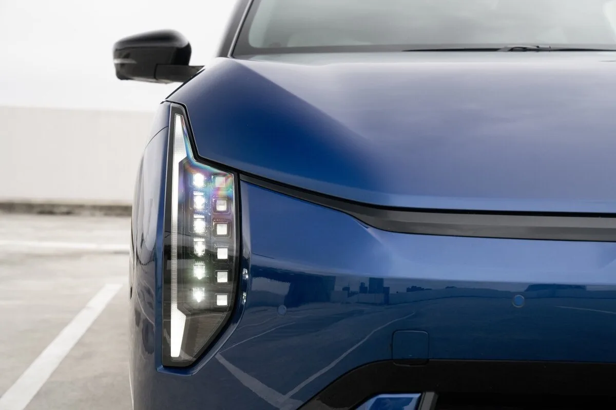 Close view of the 2026 Kia EV4 Earth Long Range front headlight and blue bonnet