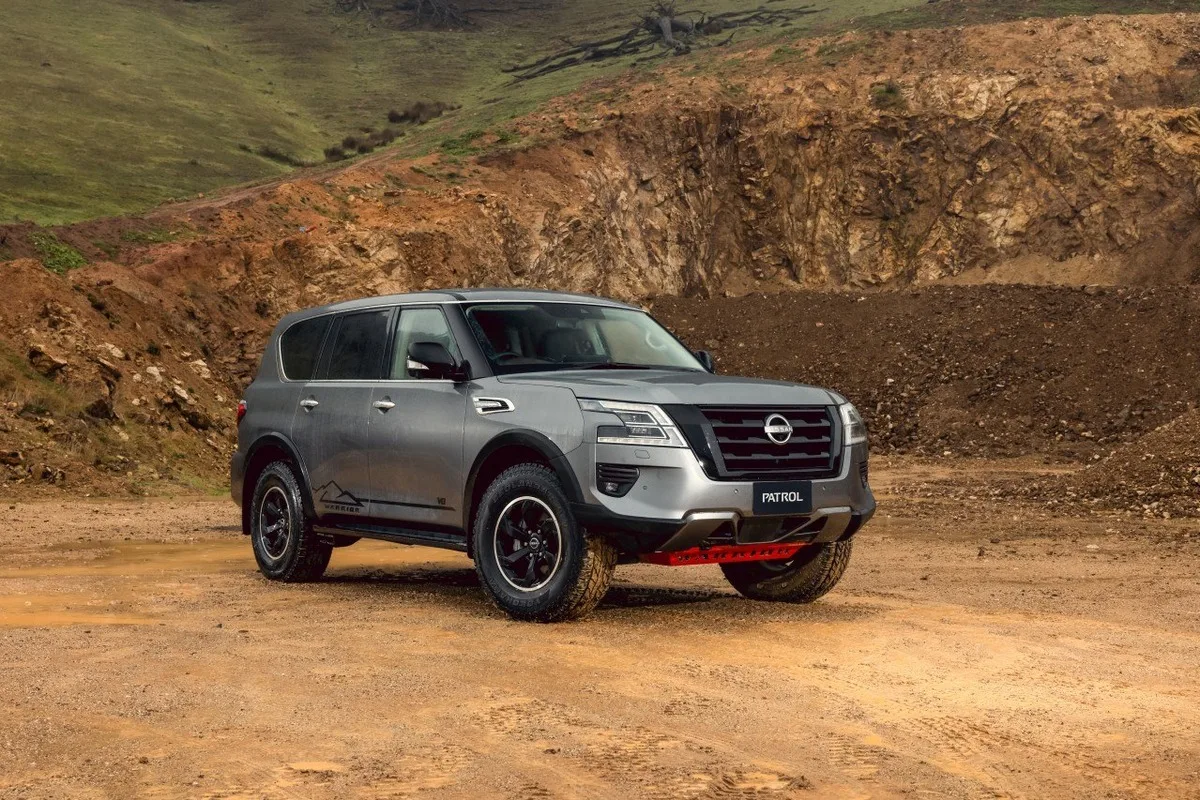 Grey Nissan Patrol Warrior shown from the front three-quarter angle with red underbody bash plate.