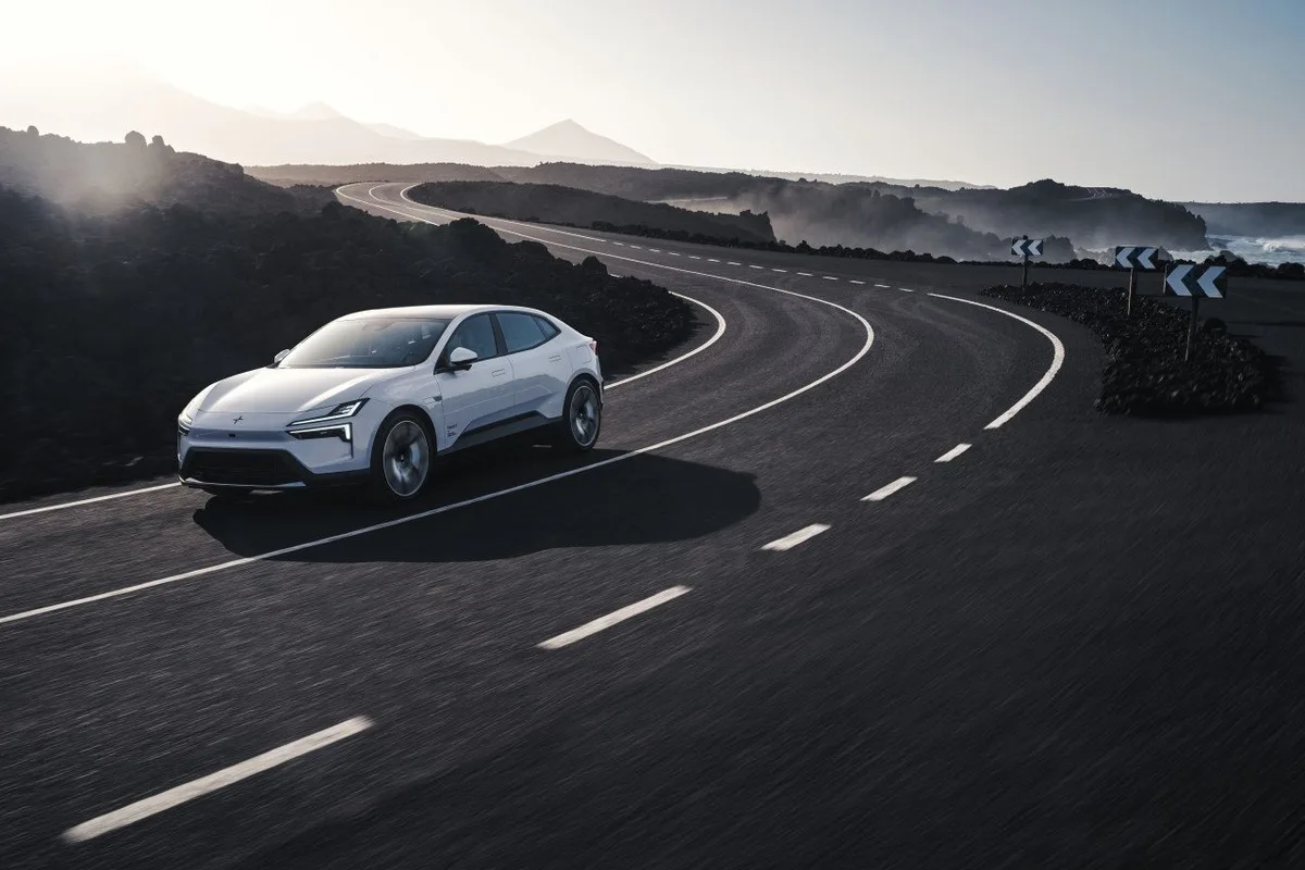 2027 Polestar 4 front corner view driving through a winding road