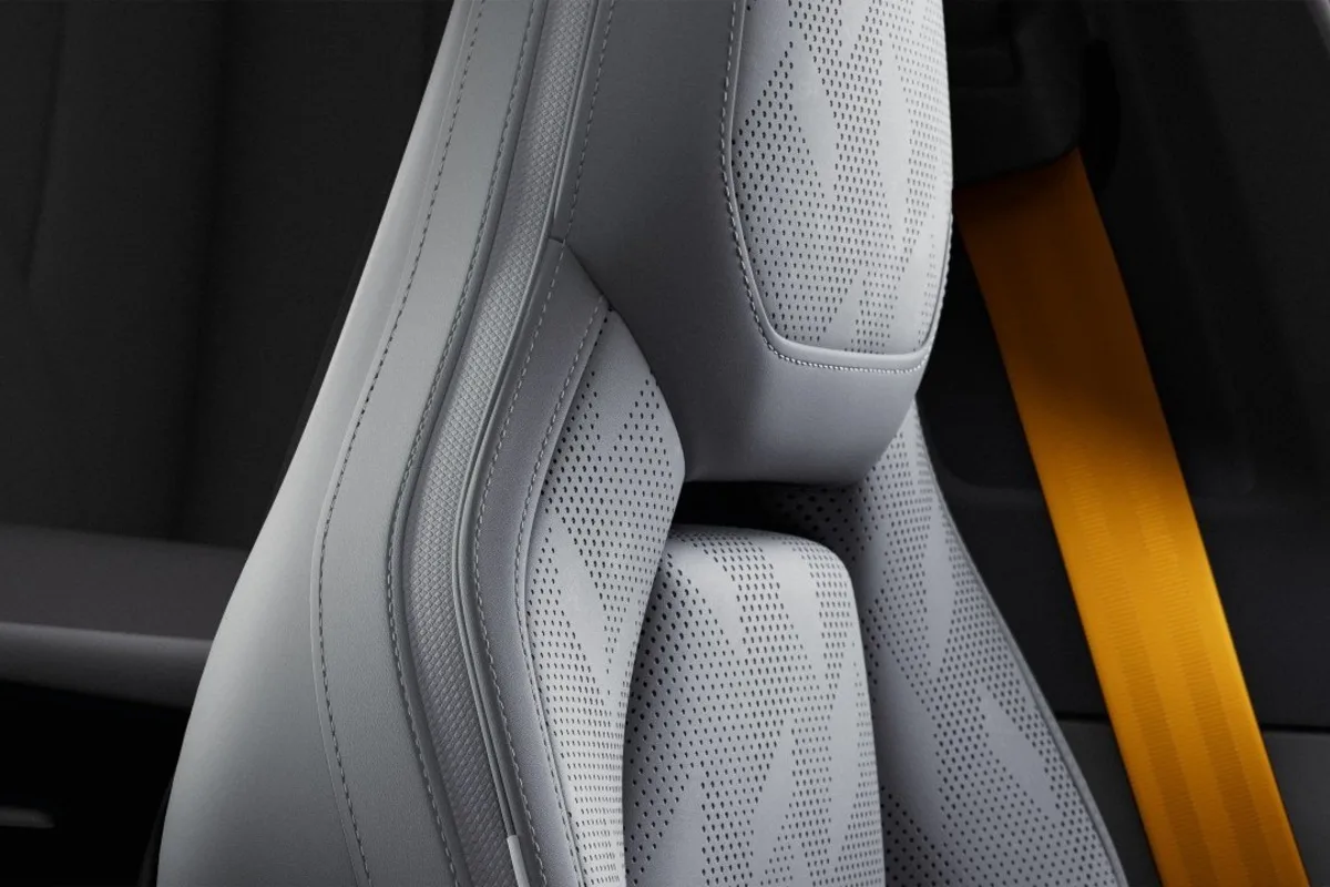 2027 Polestar 4 front seat detail with perforated upholstery and gold seatbelt