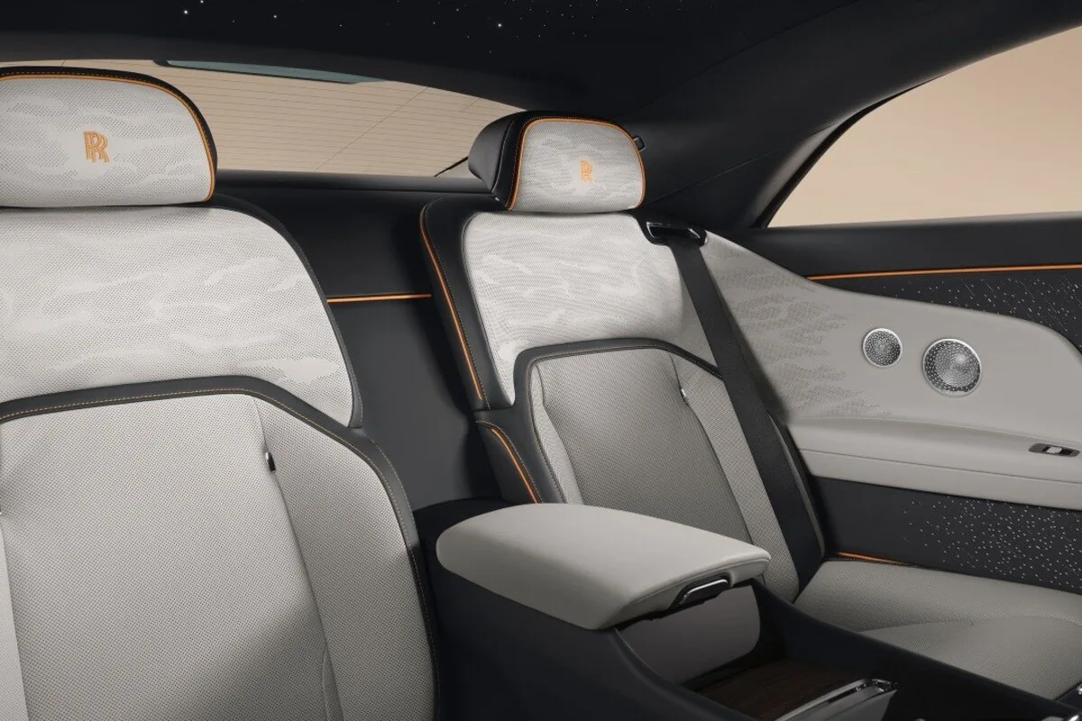 Rolls-Royce Spectre Series II rear cabin with light leather and illuminated trim.