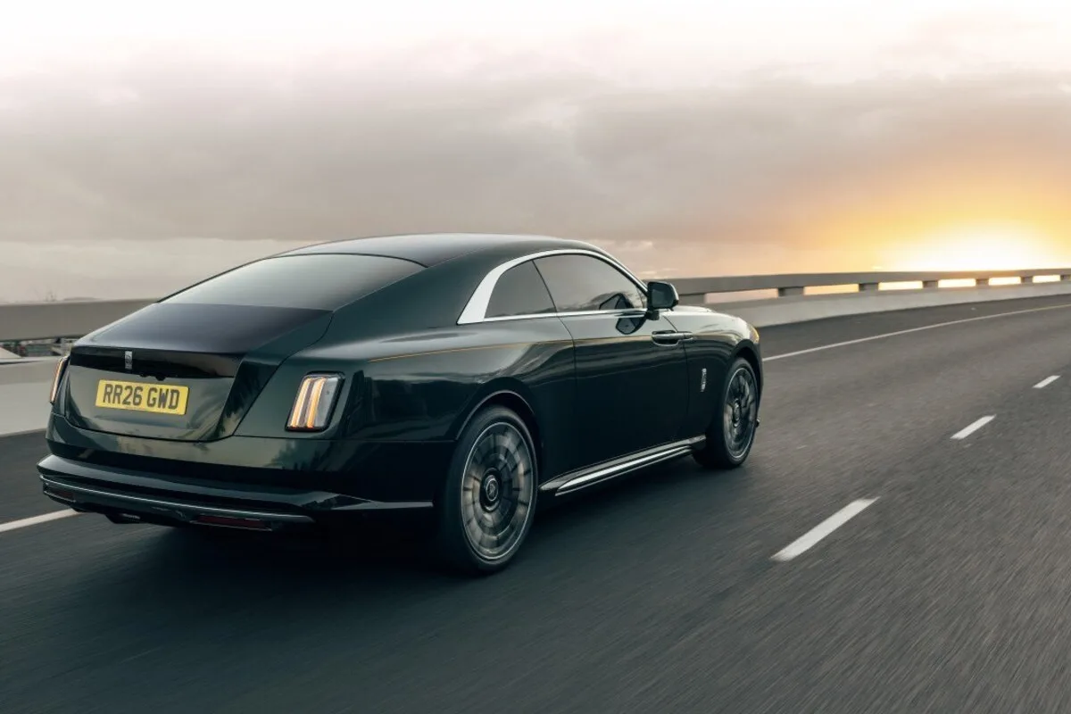 Rolls-Royce Spectre Series II rear three-quarter view on the road at sunset.
