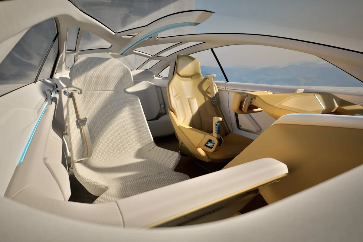 Cream and gold cabin of the Kia Vision Meta Turismo with a glass canopy and lounge-style seating