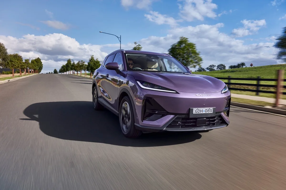Purple Lepas L6 EV driving on a tree-lined street