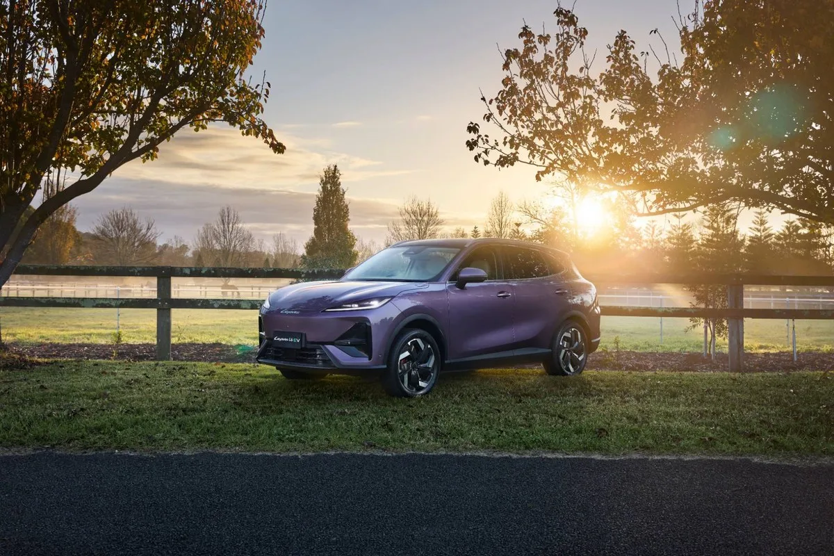 Purple Lepas L6 EV parked on grass at sunset