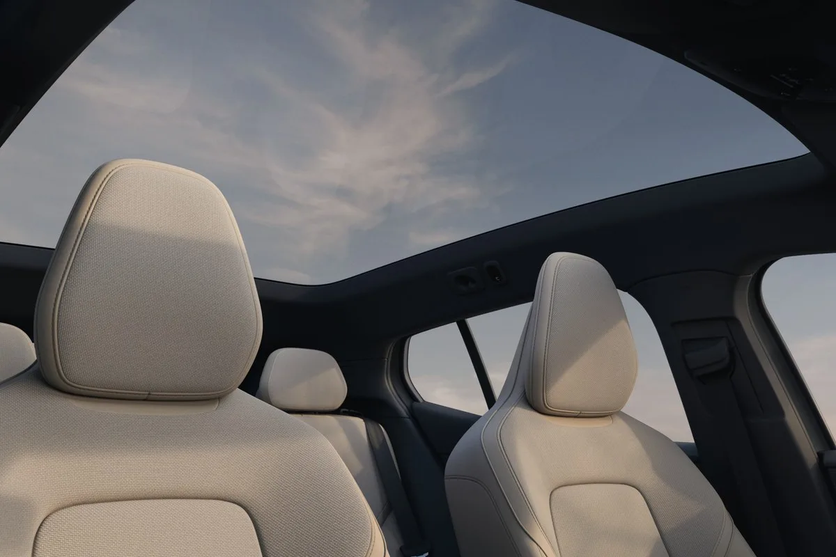 Panoramic glass roof and cream front seats inside the Volvo EX30