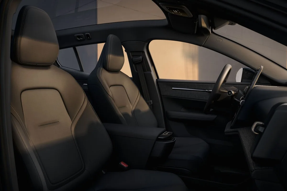 Tan and black interior of the Volvo EX30 with steering wheel and dashboard