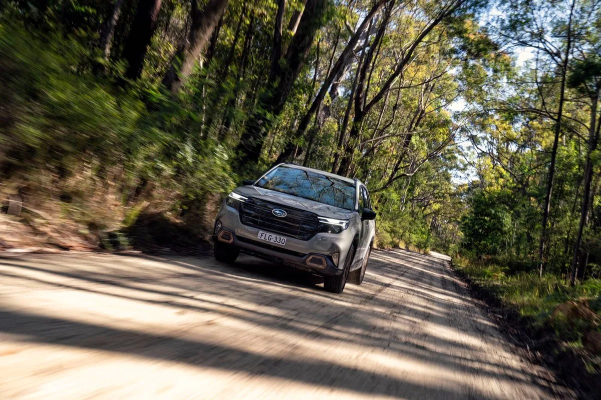 Subaru Forester Hybrid driving on a shaded dirt forest road
