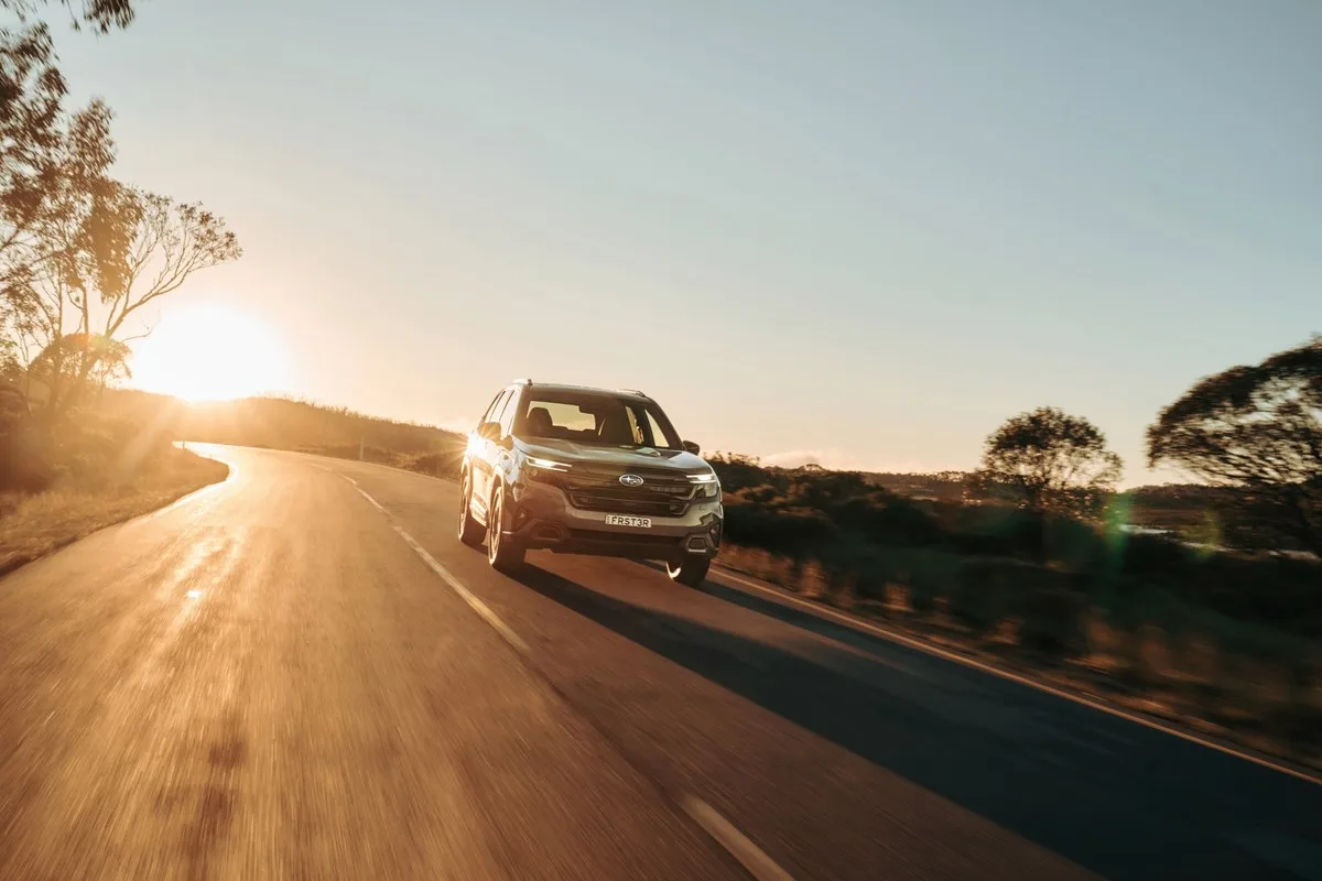 Subaru Forester Hybrid driving on a country road into the sun