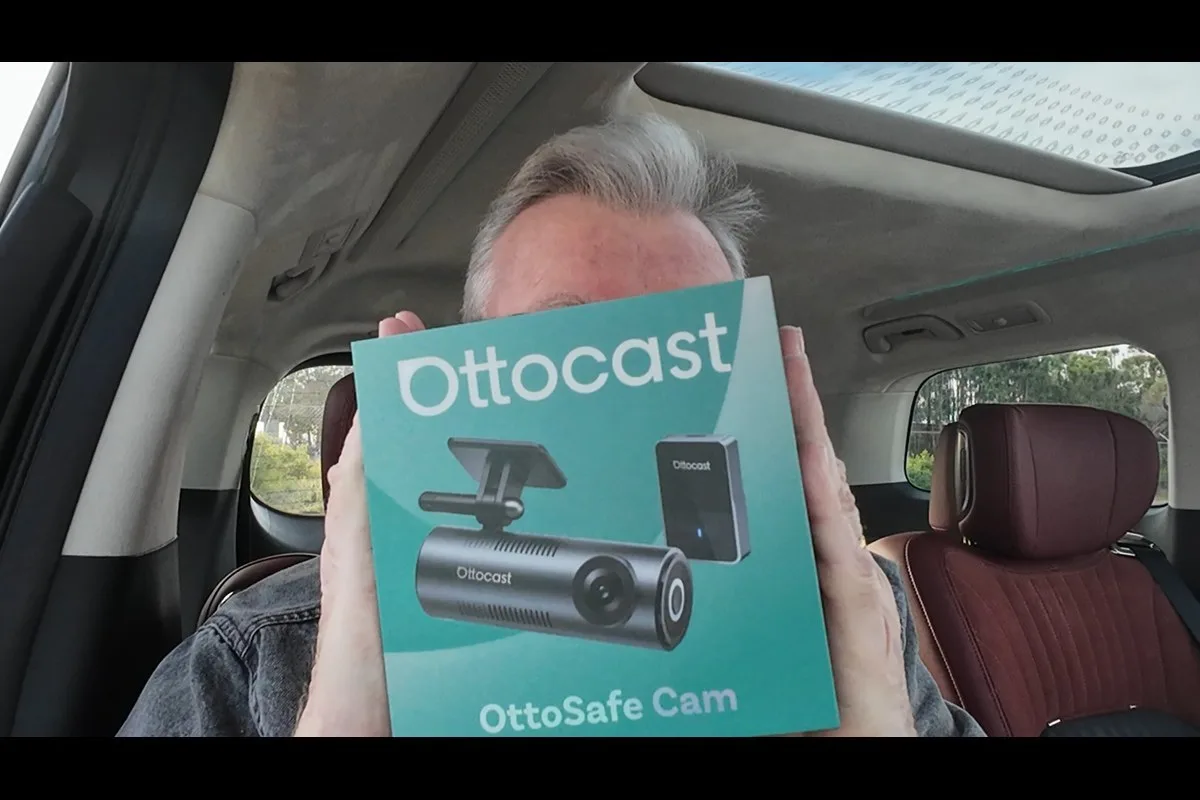 OttoSafe Cam retail box held up inside a car
