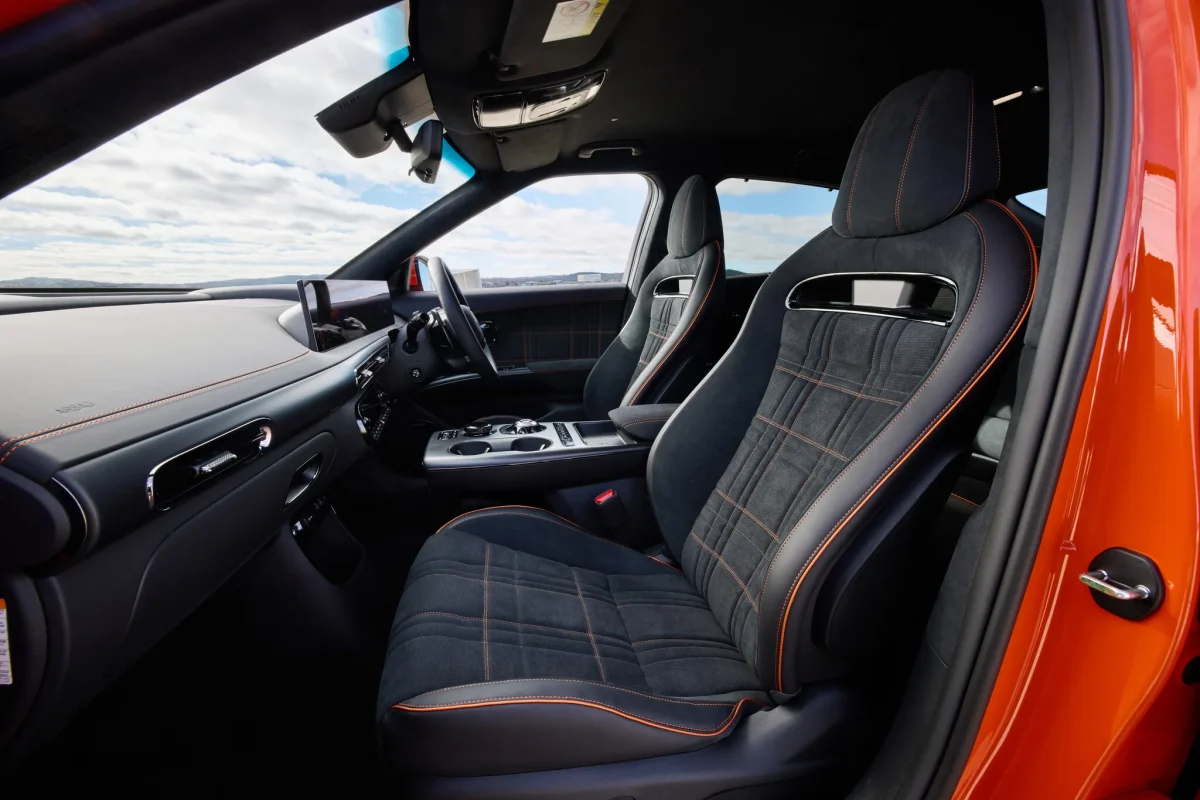 Genesis GV60 Magma black sport front seats with orange accents and bolstering