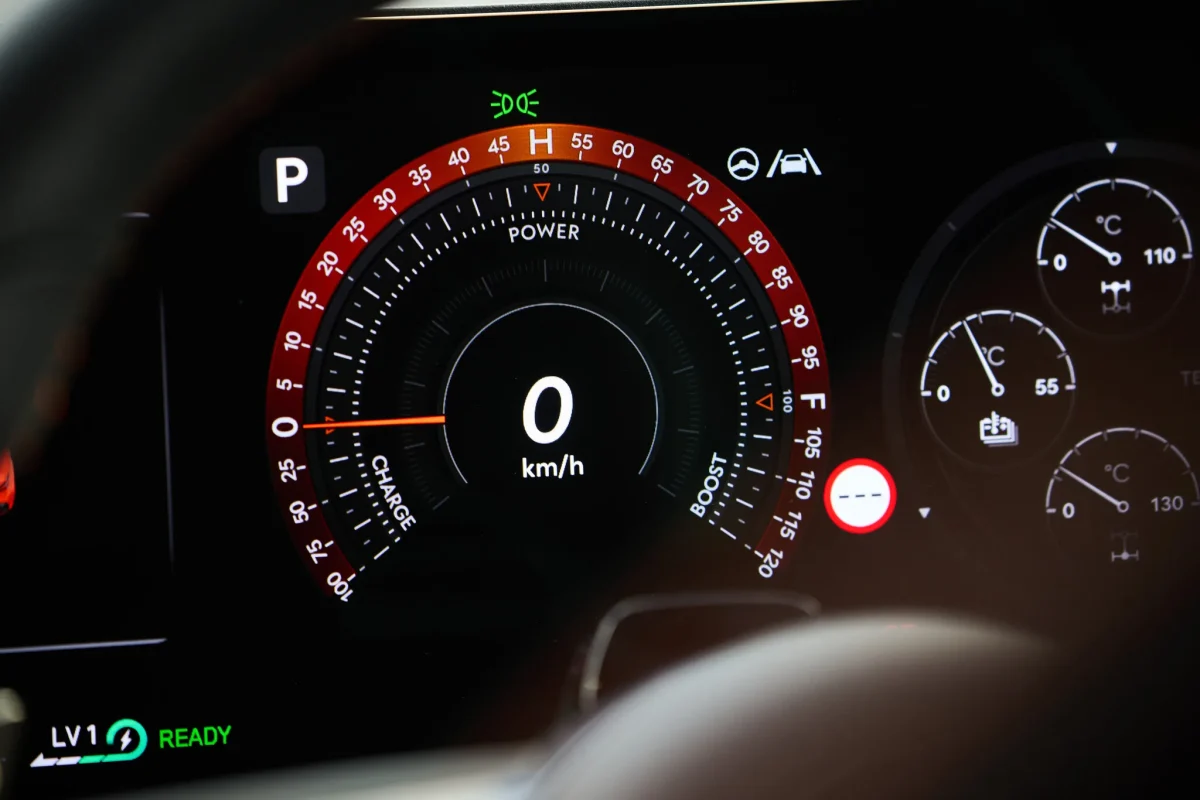 Genesis GV60 Magma digital instrument cluster showing the performance power gauge