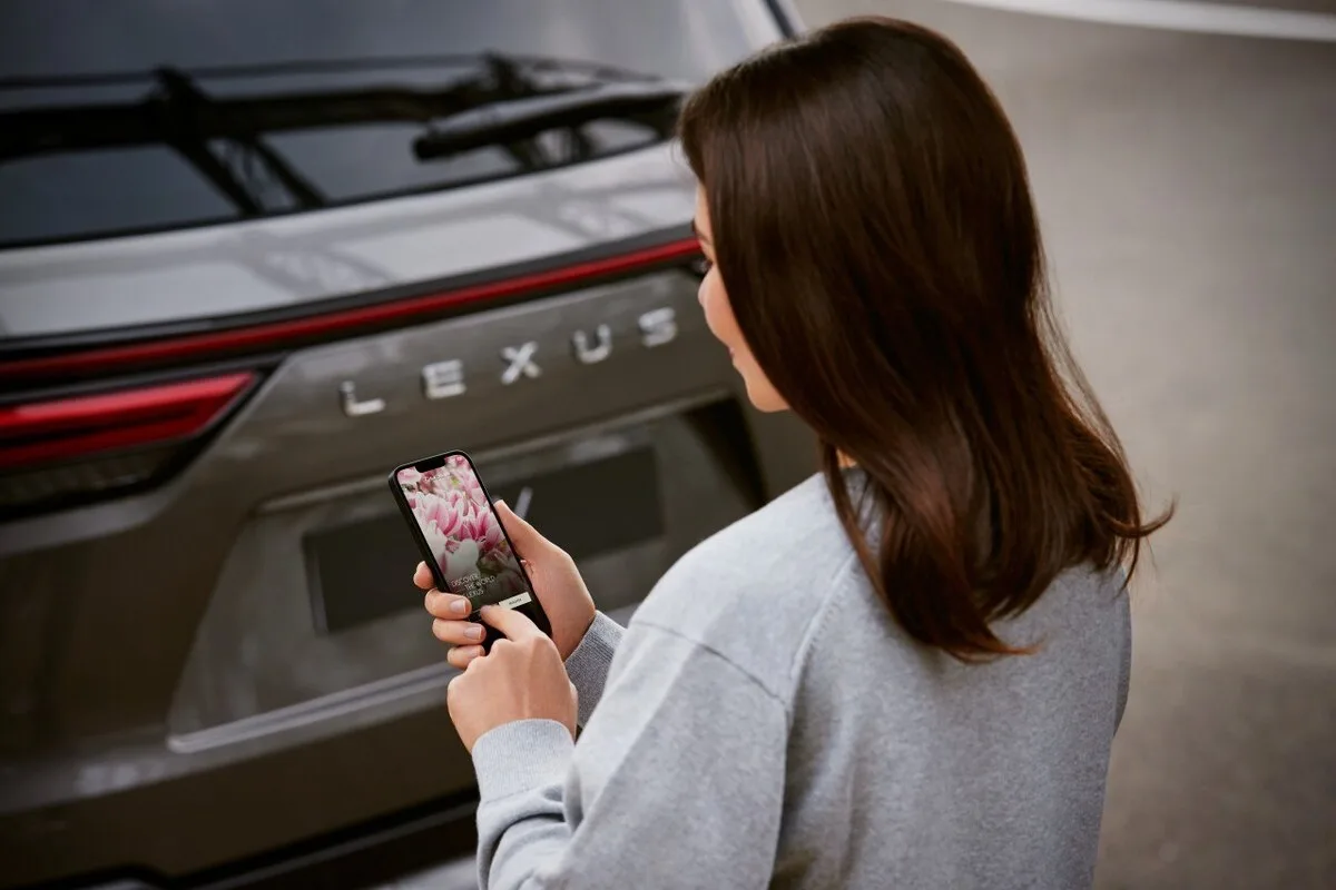Lexus connected services app being used near a Lexus vehicle