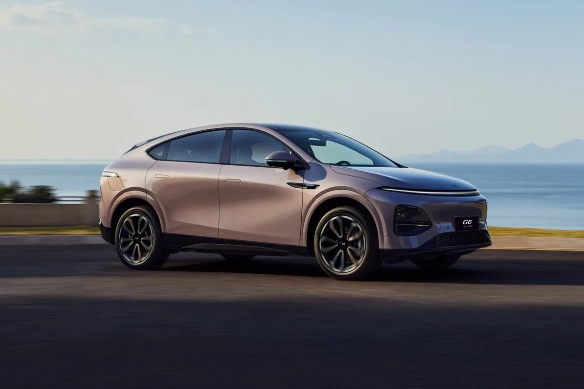XPeng G6 electric SUV side profile on a coastal road