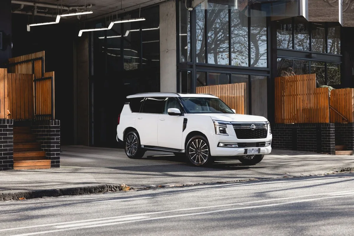 White 2027 Nissan Y63 Patrol parked at the kerb, front three-quarter view