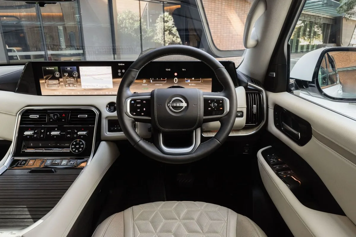 Driver's view of the Nissan Y63 Patrol steering wheel and digital instrument screen