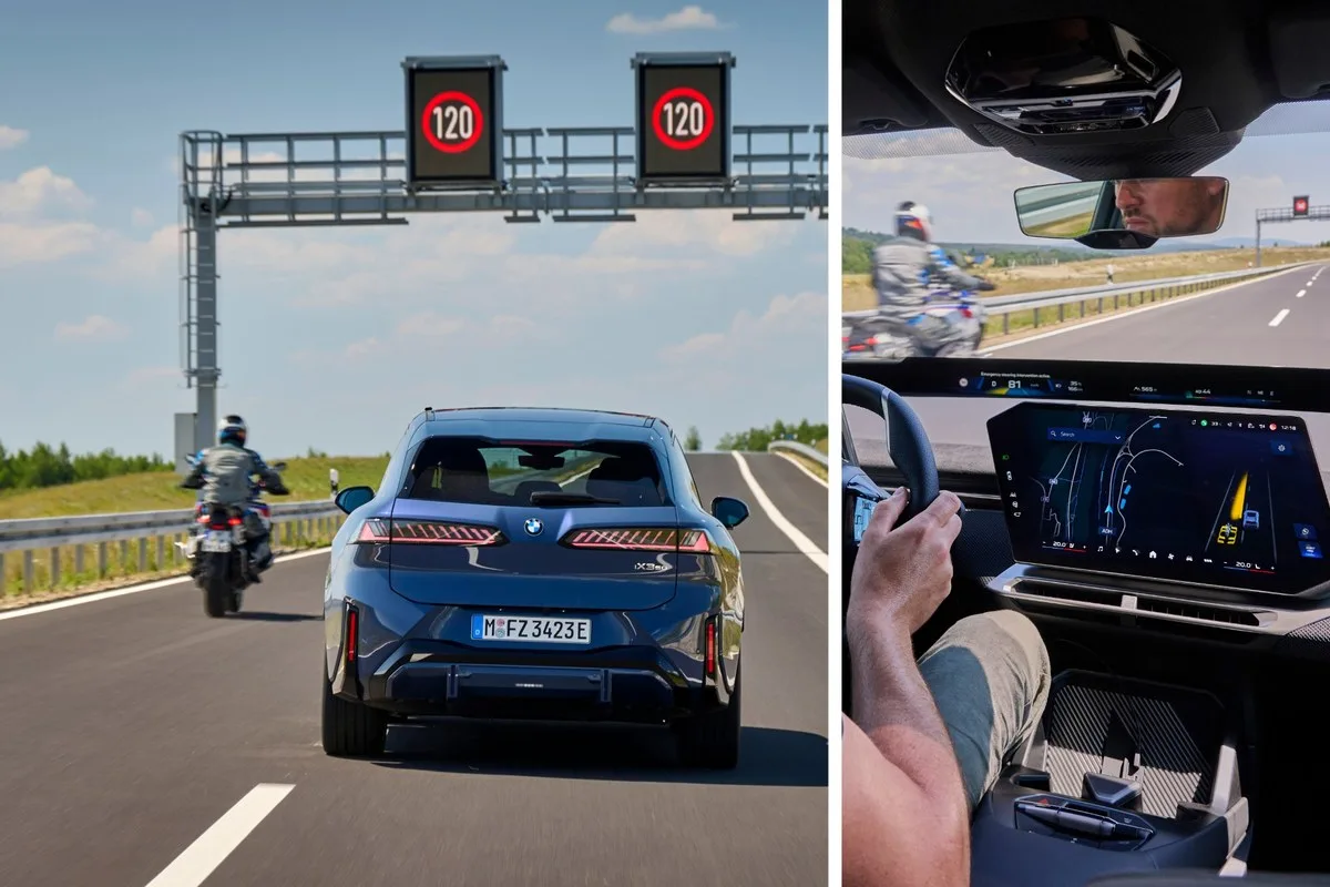 BMW iX3 on a motorway under 120 speed signs with a motorcyclist alongside, and the emergency steering message on the driver display