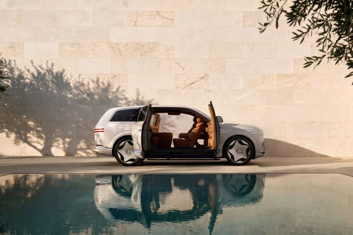 White Genesis GV90 Neolun in profile with both coach doors open and no B-pillar