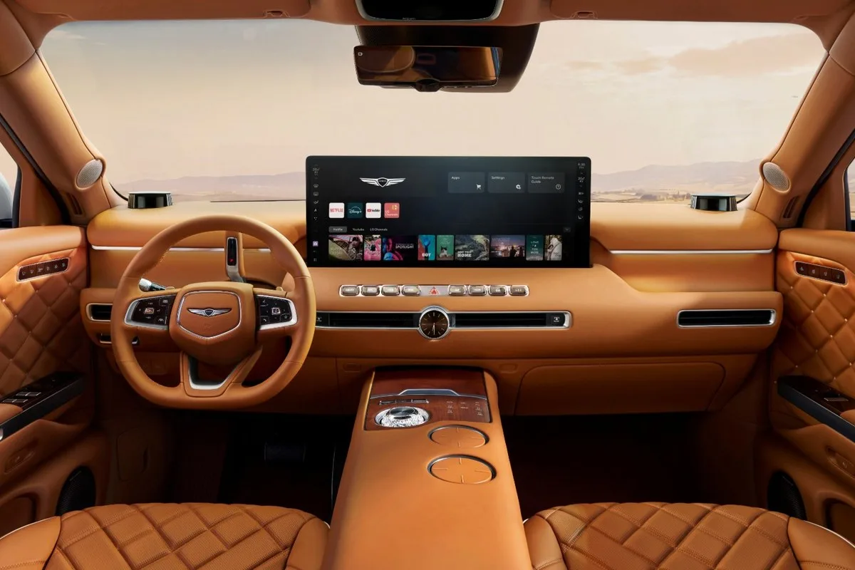 Genesis GV90 dashboard in tan leather with the wide centre screen and crystal controller