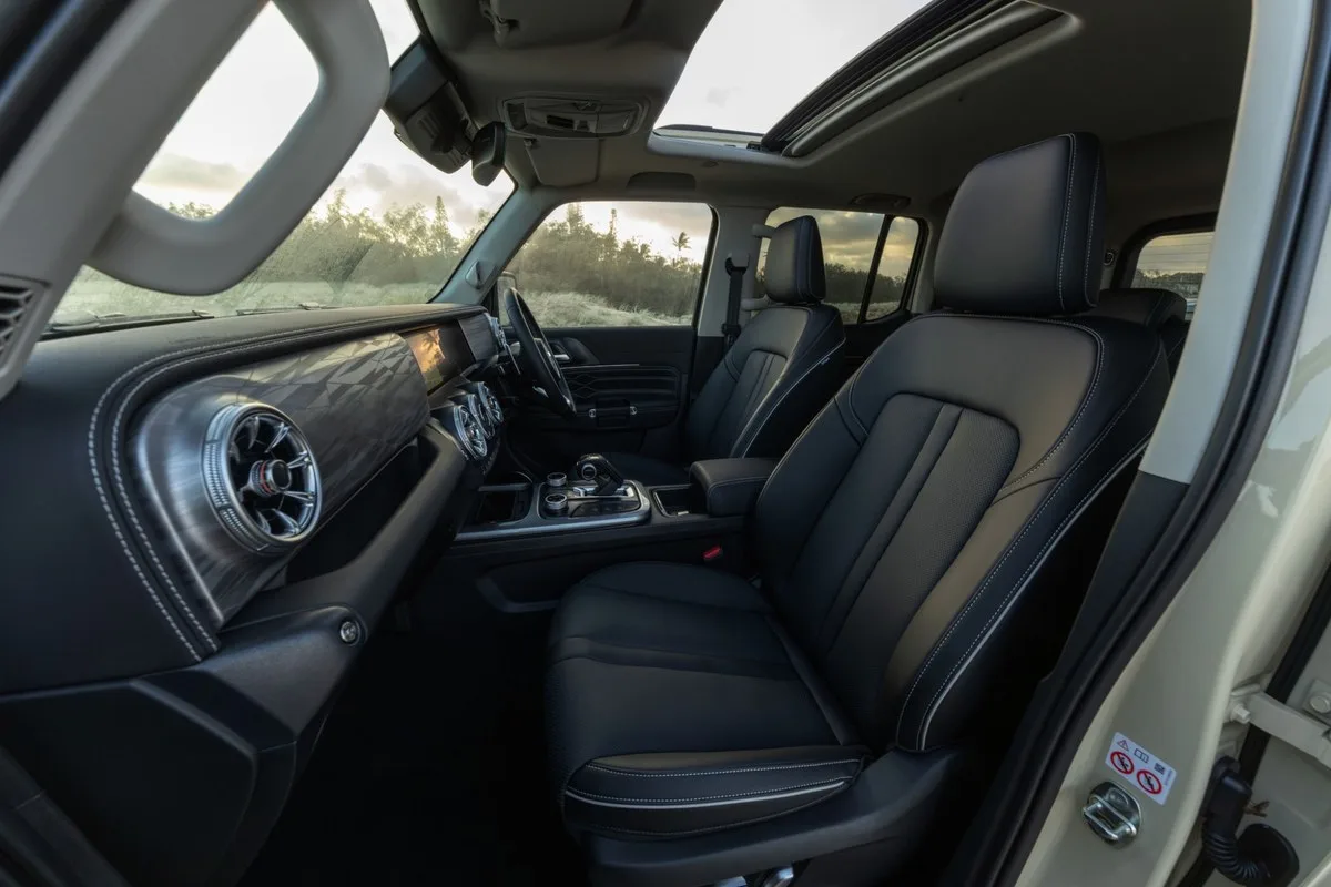 GWM Tank 300 Ultra Hi4-T front seats and dashboard at sunset with the sunroof open