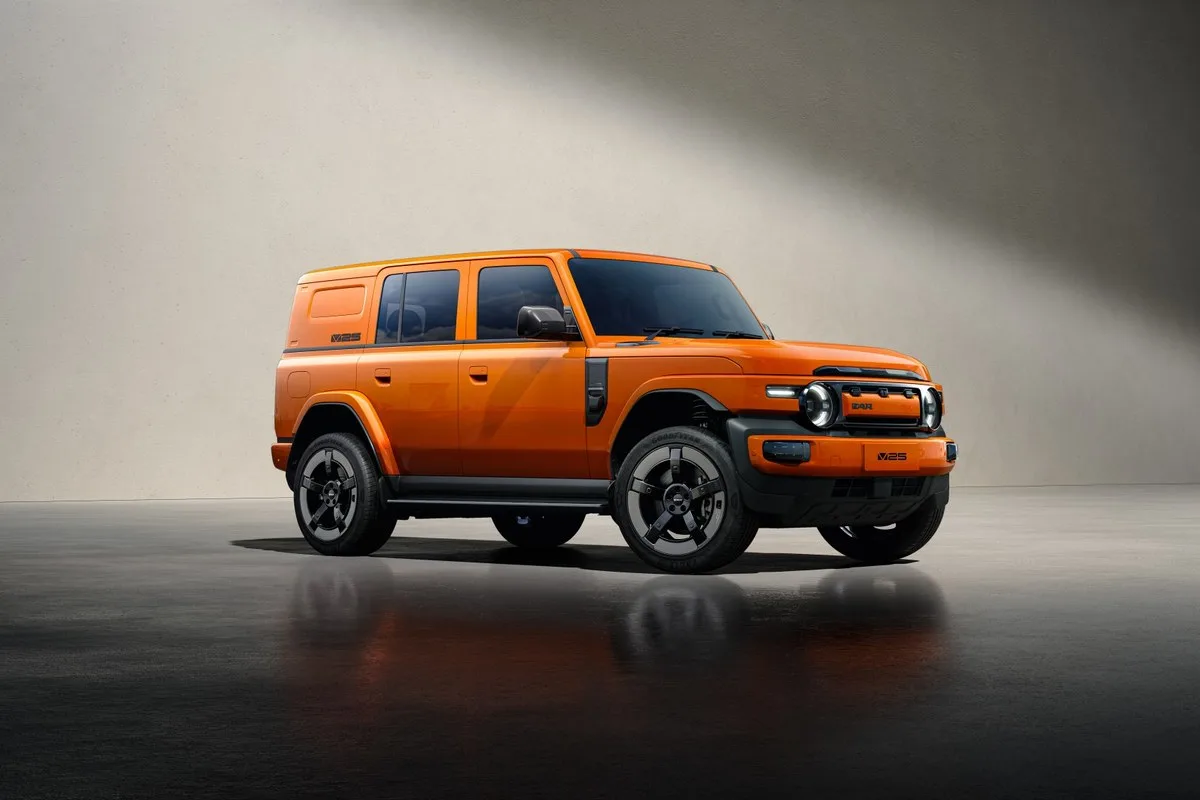 Orange iCAUR V25 electric SUV, front three-quarter view in a studio