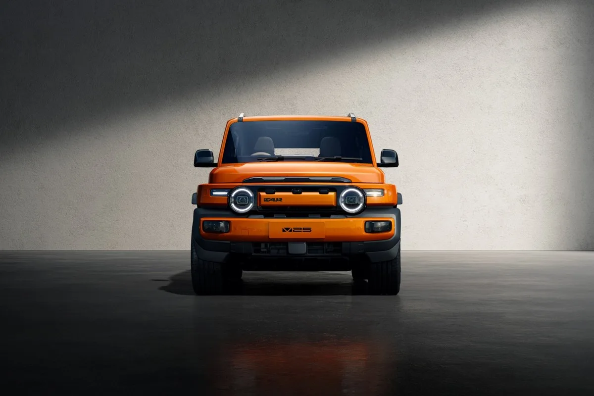 Orange iCAUR V25 head on, showing the round headlamps in a squared-off nose