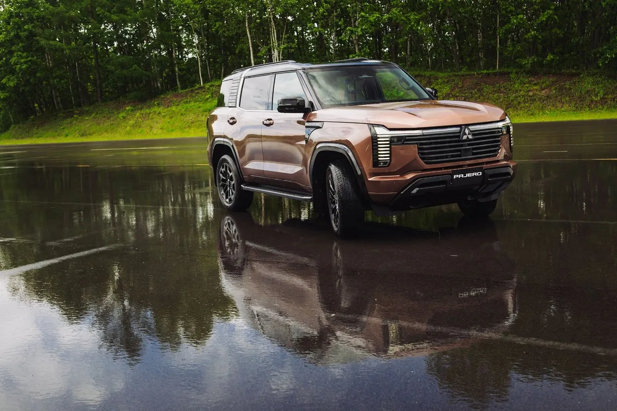 Copper 2026 Mitsubishi Pajero on a wet test track, front three-quarter view